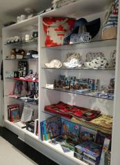 Store shelves filled with Canadian-themed souvenirs, including mugs, hats, and trinkets.